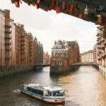 Sightseeing boat cruising through Hamburg Speicherstadt canals