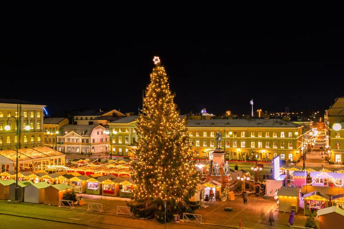 Helsinki Christmas market in Senate Square with a large illuminated Christmas tree