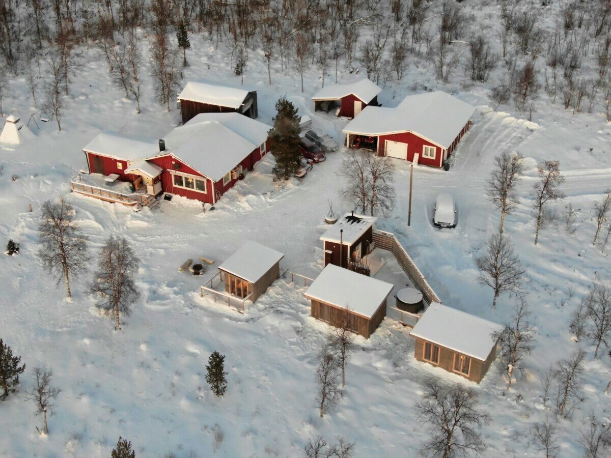Snow-covered buildings and birch forest in Kiruna, Swedish Lapland