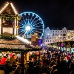Kraków Christmas market with festive stalls and Ferris wheel