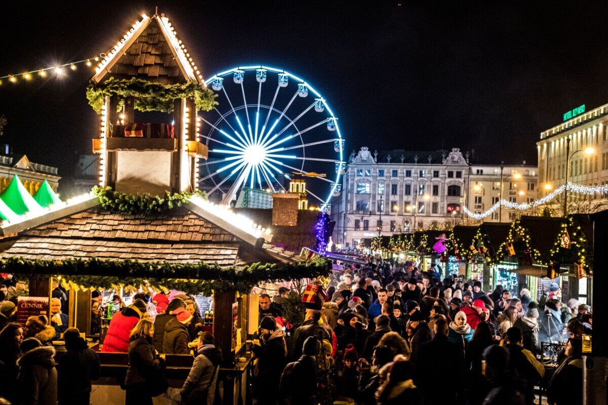 Kraków Christmas market with festive stalls and Ferris wheel