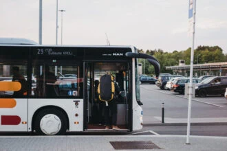 Passenger boarding a public bus at Luxembourg Airport