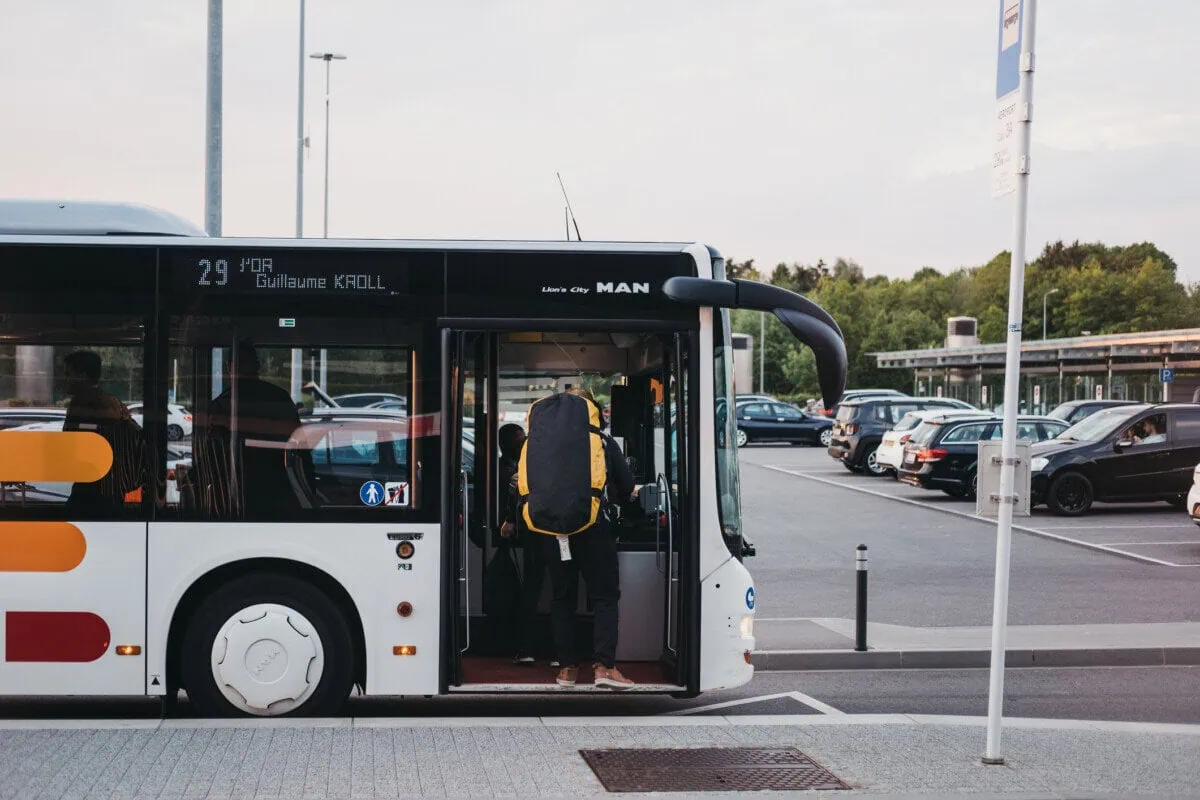 Passenger boarding a public bus at Luxembourg Airport