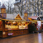 Wooden Christmas market stalls decorated with festive lights in Luxembourg City