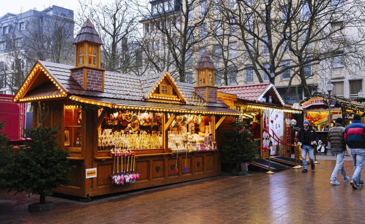 Wooden Christmas market stalls decorated with festive lights in Luxembourg City