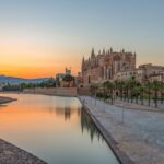 Palma Cathedral at sunset beside the waterfront in Mallorca