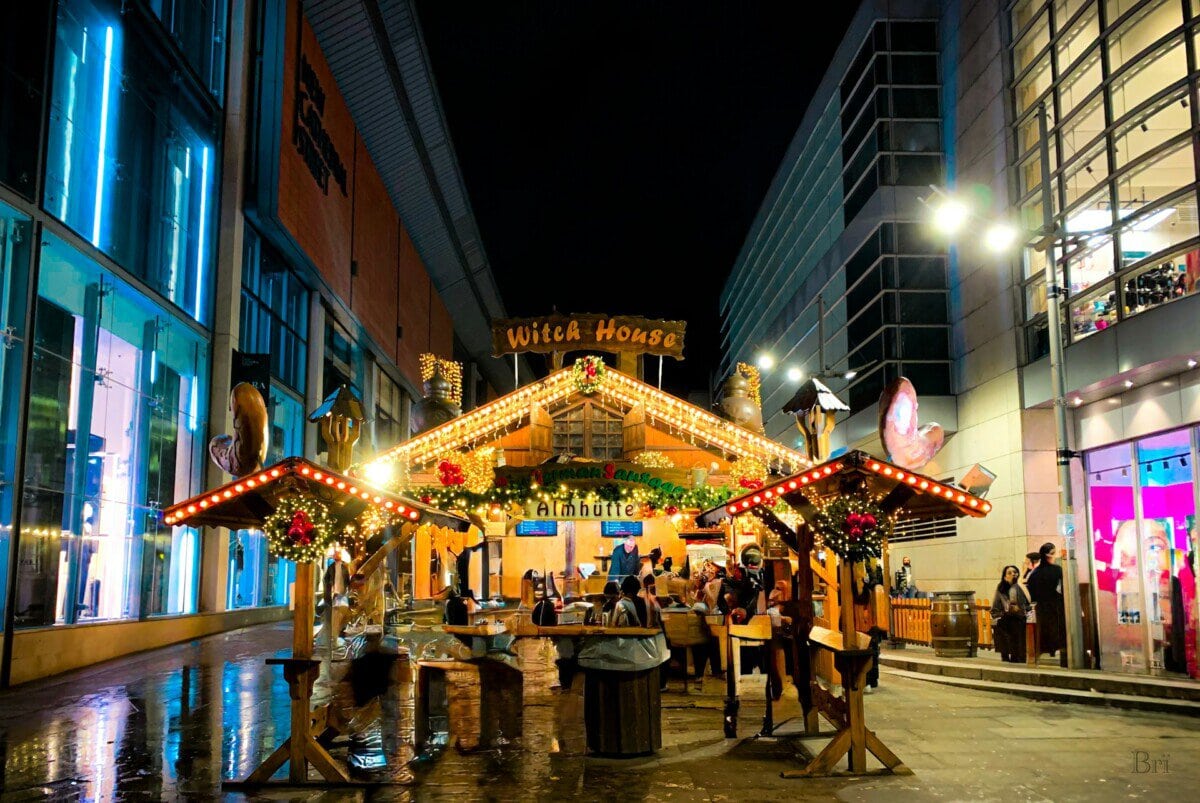 Manchester Christmas market stall decorated with festive lights