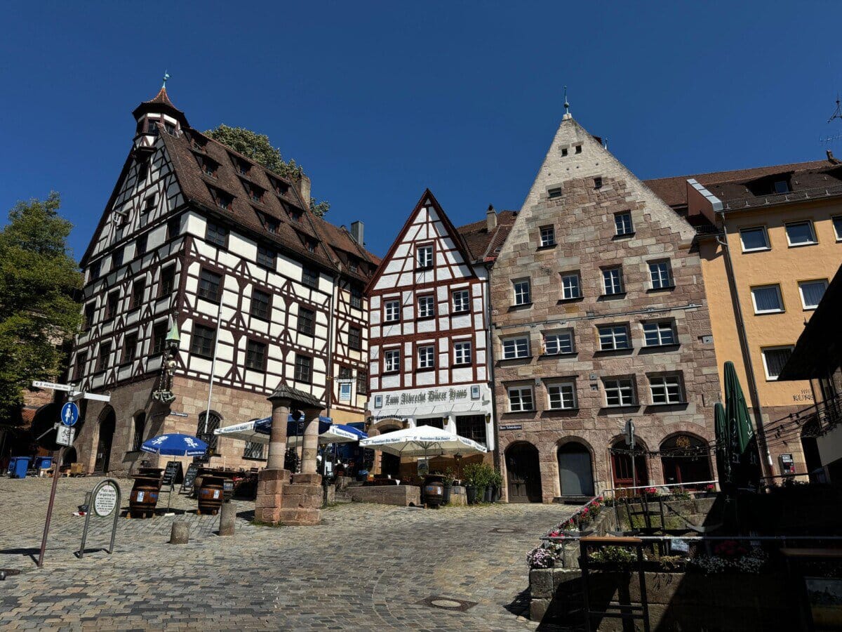 Half-timbered houses and historic buildings on a cobbled square in Nuremberg