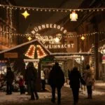 Snowy Nuremberg Christmas market with festive lights and wooden stalls at night