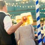 Oktoberfest server carrying beer steins in a Munich beer tent