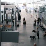 Passengers with luggage at Paris Orly Airport terminal