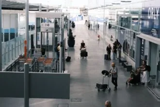 Passengers with luggage at Paris Orly Airport terminal