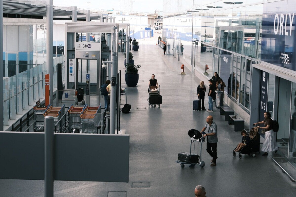 Passengers with luggage at Paris Orly Airport terminal