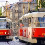 Red and white trams running through central Prague