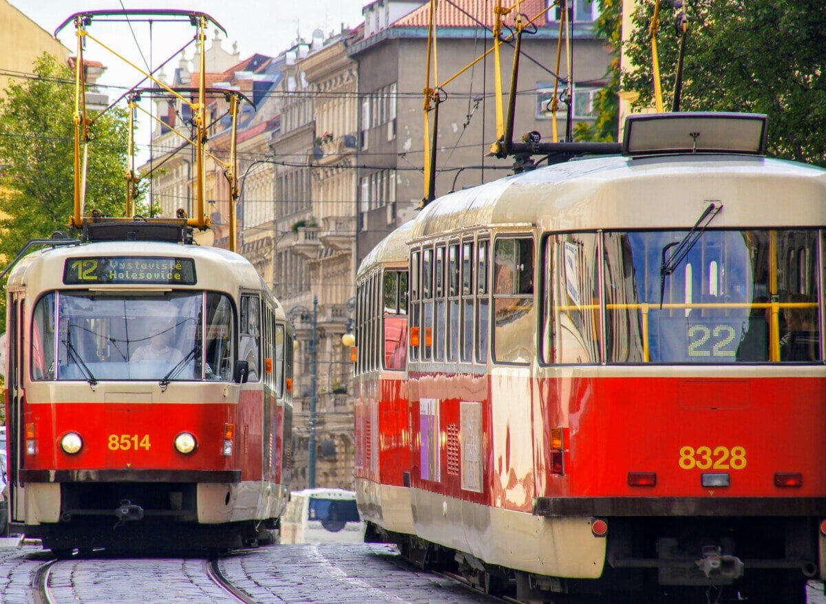 Red and white trams running through central Prague