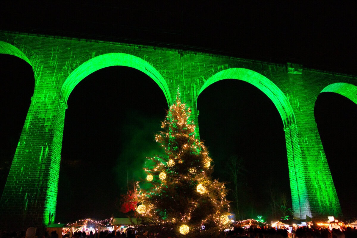 Ravenna Gorge Christmas Market beneath the illuminated railway viaduct in Germany