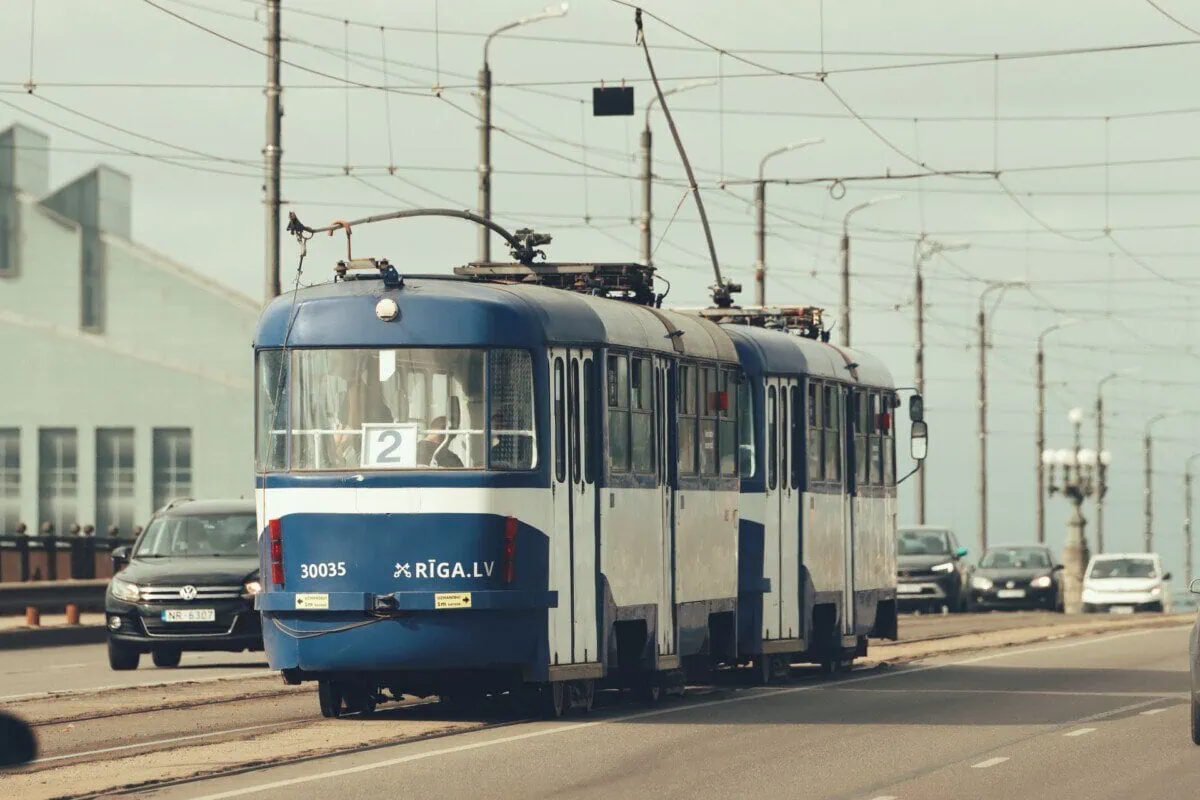 Blue and white tram travelling through Riga, Latvia