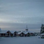 Snow-covered buildings and pine trees in Rovaniemi, Finnish Lapland