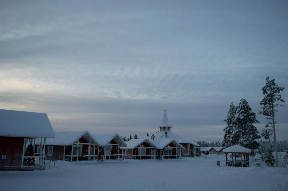 Snow-covered buildings and pine trees in Rovaniemi, Finnish Lapland