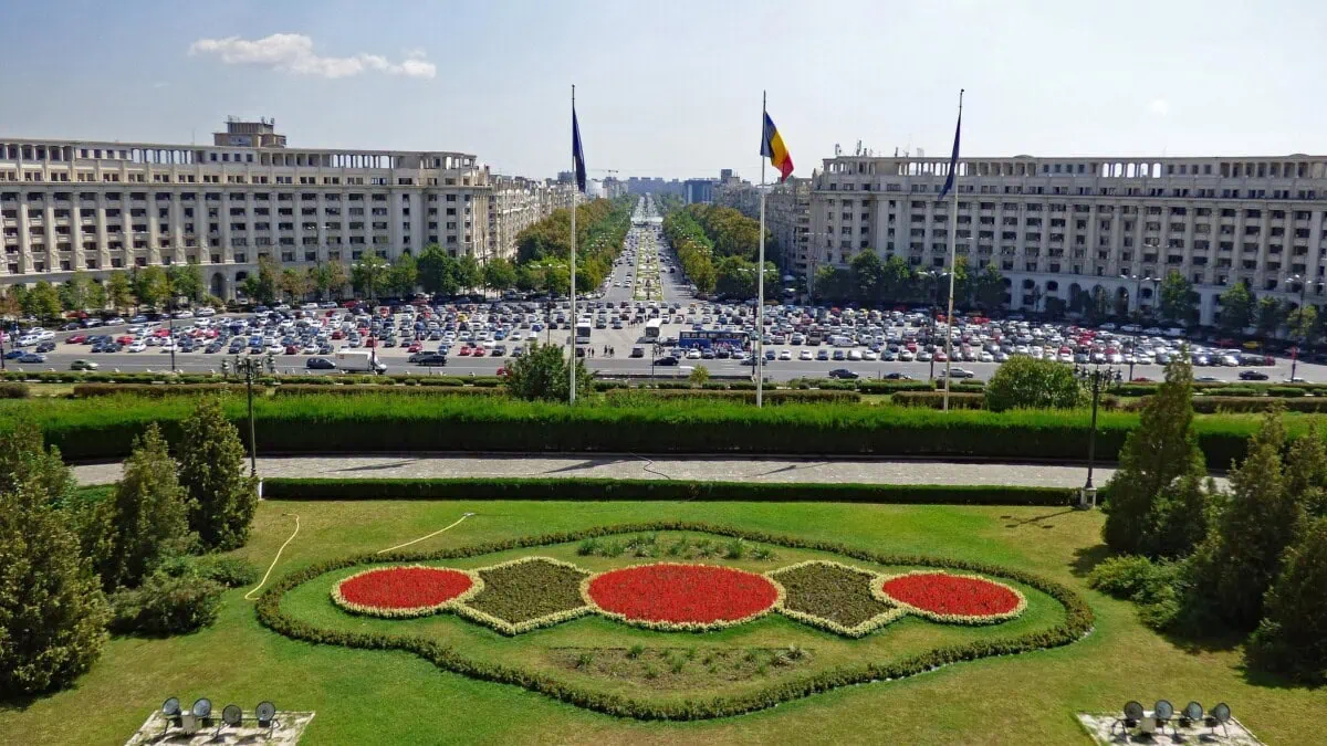View across central Bucharest and Piața Constituției with the Romanian flag and city boulevards