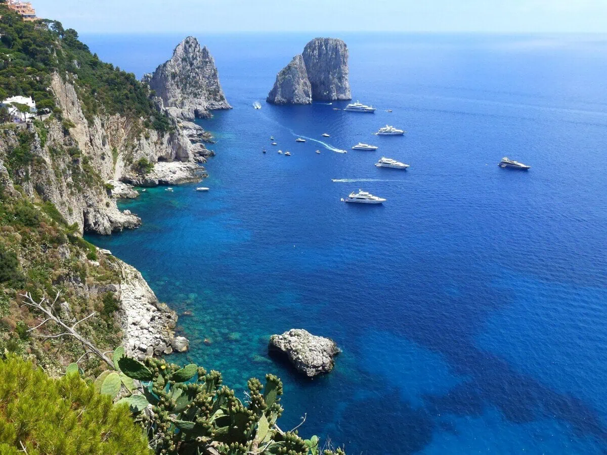 Faraglioni sea stacks and boats in the blue Mediterranean off Capri