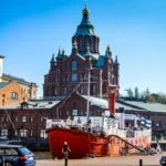 Uspenski Cathedral overlooking Helsinki waterfront with a red lightship moored in the harbour
