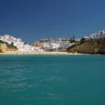 Sandy beach, cliffs and whitewashed buildings on the Algarve coast near Lagos