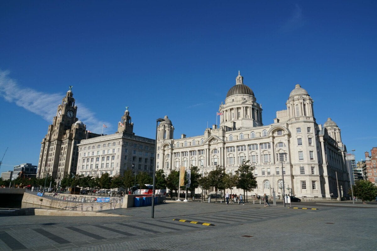 Liverpool waterfront with the Royal Liver Building, Cunard Building and Port of Liverpool Building under a blue sky