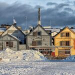 Snow-covered wooden buildings in central Oulu, Finland
