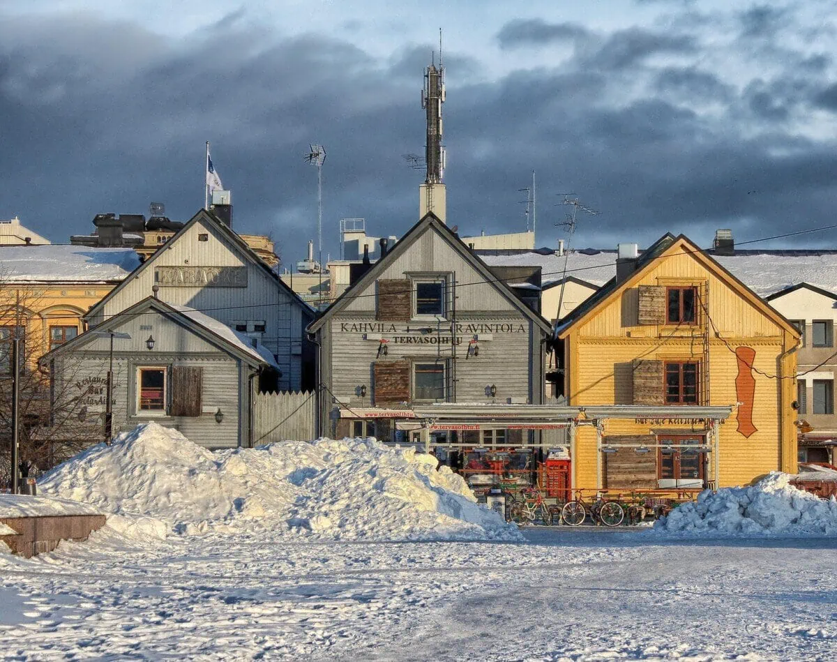Snow-covered wooden buildings in central Oulu, Finland