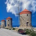 Historic stone windmills at Mandraki Harbour in Rhodes Town