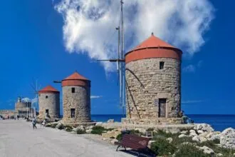 Historic stone windmills at Mandraki Harbour in Rhodes Town