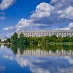 Nuremberg Congress Hall beside the Dutzendteich lake under a blue sky
