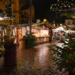 Christmas market stalls decorated with festive lights and Christmas trees in Trier, Germany