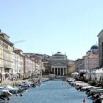 Canal Grande in central Trieste lined with boats and historic buildings