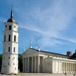 Vilnius Cathedral and its white bell tower beneath a clear blue sky